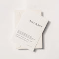 Minimalist wedding invitation card with serif typography, Alice & Joey names on ivory paper with envelope, modern elegant flat lay