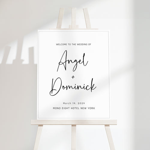 Minimal wedding welcome sign with clean serif typography displayed on a modern easel, featuring a soft off-white background and subtle natural shadowing.