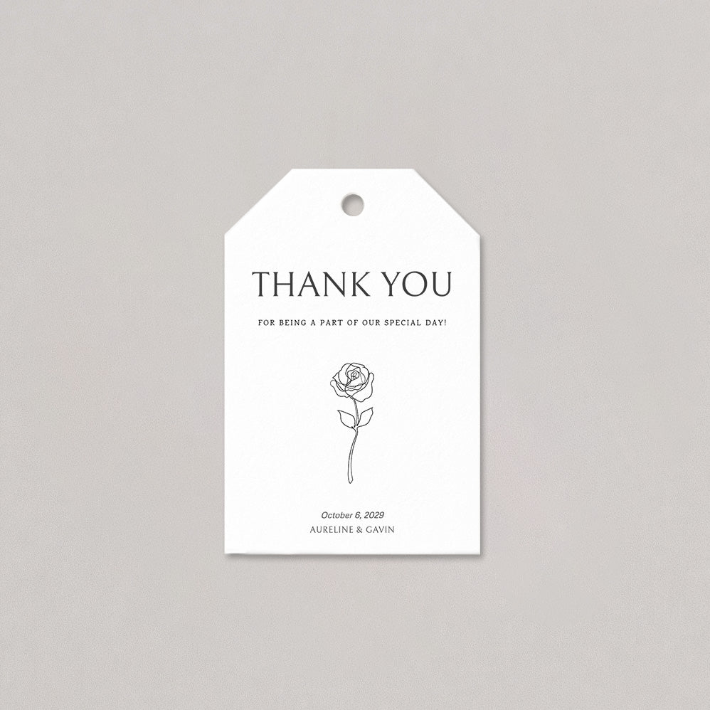 Elegant wedding favor tag with clean serif typography, a simple floral line detail, and a smooth white cord on a light background.