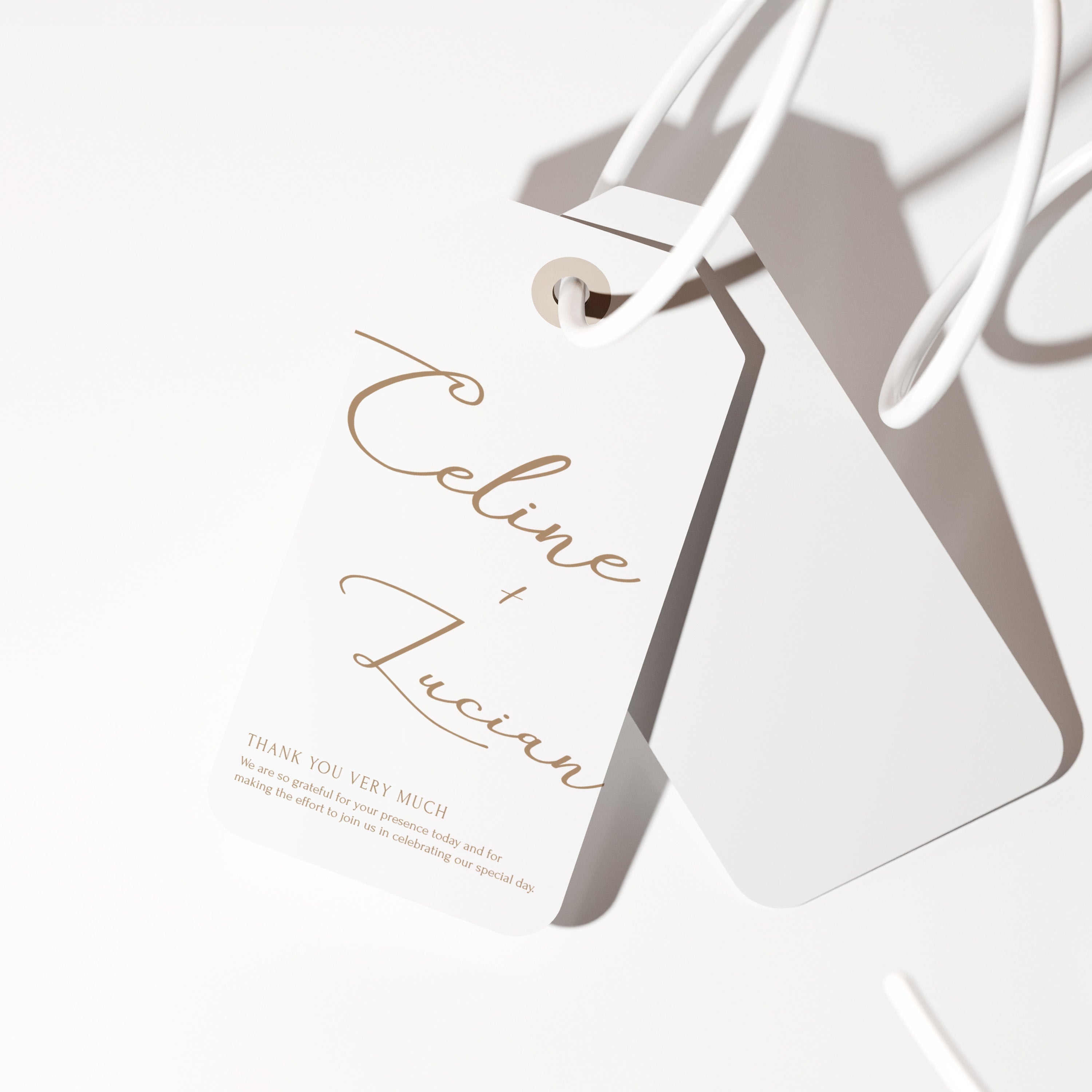 Wedding favor tag with handwritten script names on a minimal dark background