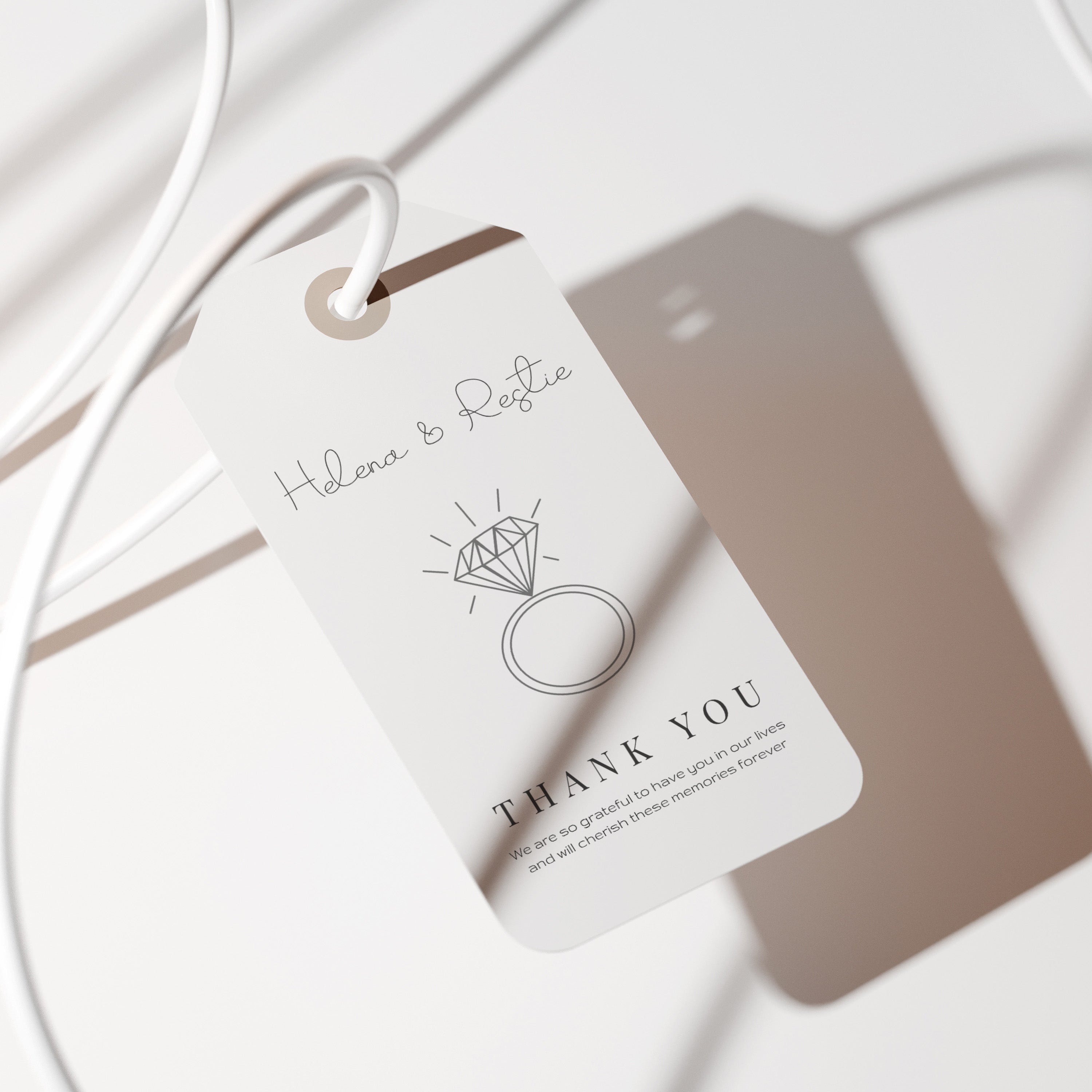 White jewelry tag with 'Helenae & Rustic' branding on a white surface