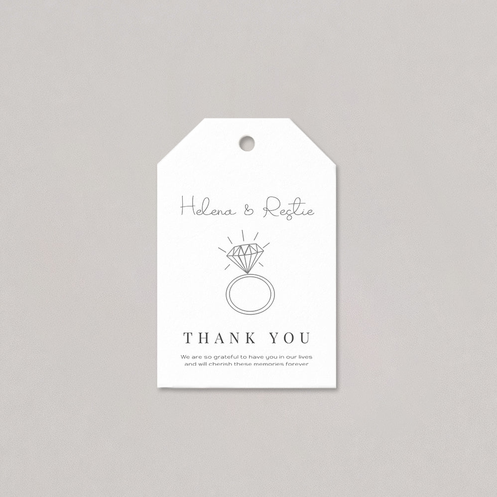 White tag with black text and ring illustration on a gray background