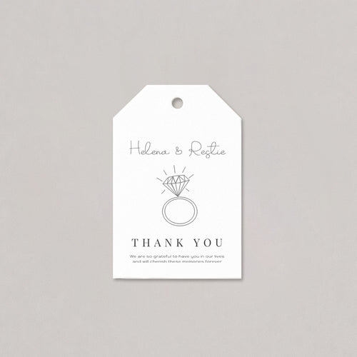 White tag with black text and ring illustration on a gray background