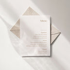 Minimal wedding menu with a vertical column layout, printed on white textured paper with refined typography.
