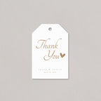 White tag with 'Thank You' and a heart in gold on a gray background
