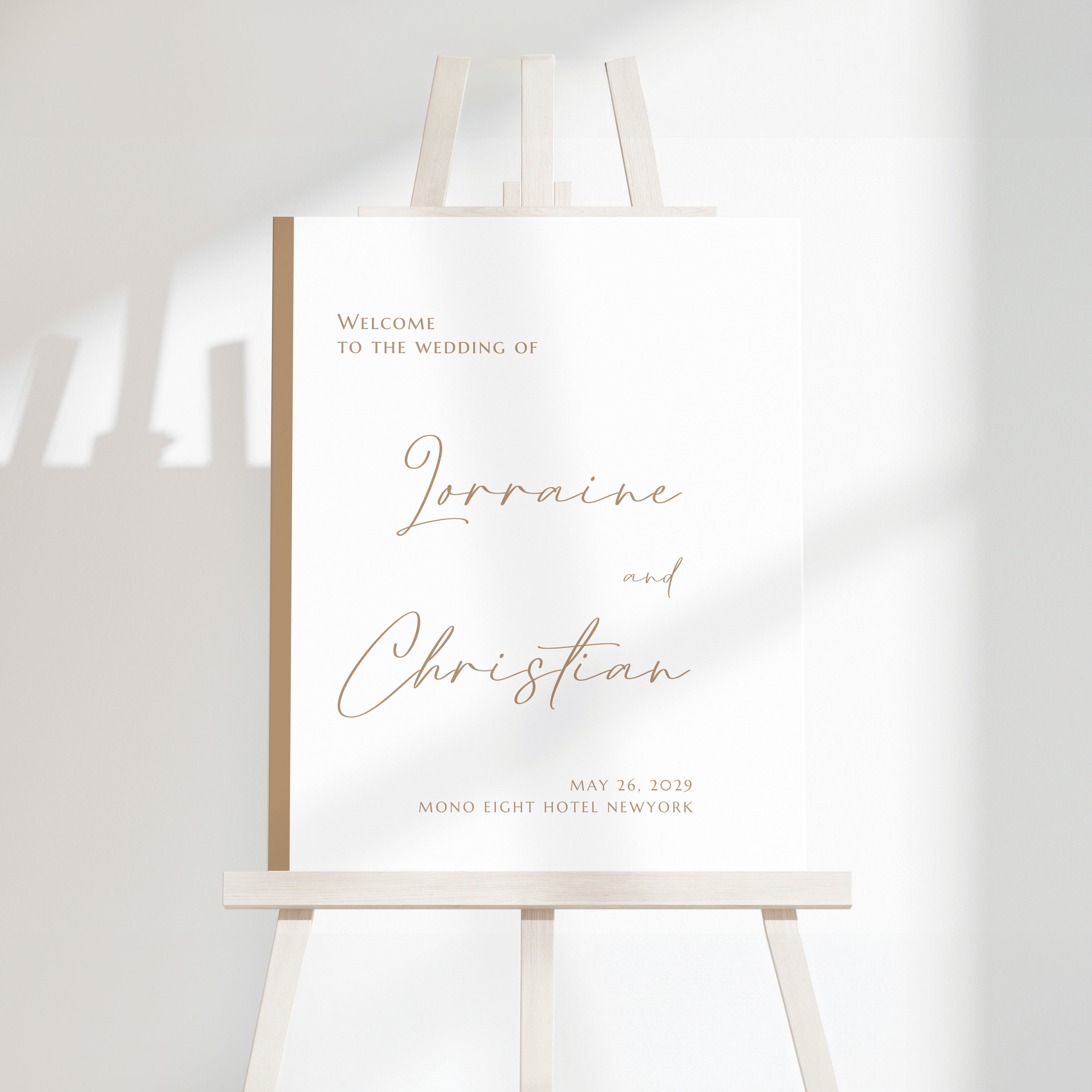 Minimal modern wedding welcome sign with warm script names and clean serif typography on a light neutral background